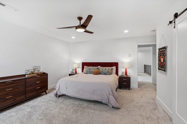 bedroom with visible vents, recessed lighting, a barn door, carpet floors, and baseboards