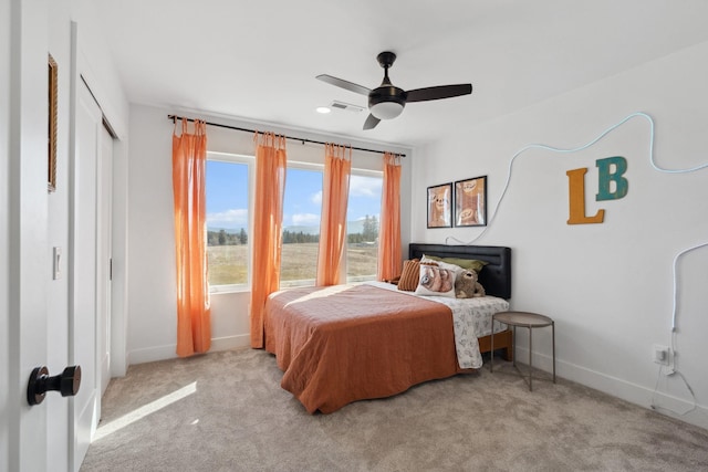 bedroom featuring visible vents, a ceiling fan, baseboards, and carpet floors