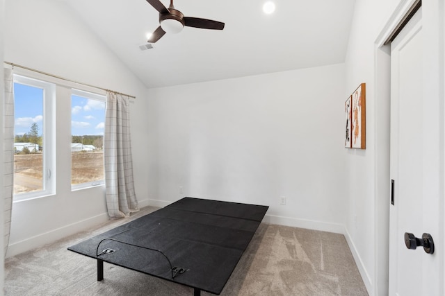 exercise area with a ceiling fan, vaulted ceiling, carpet, and baseboards