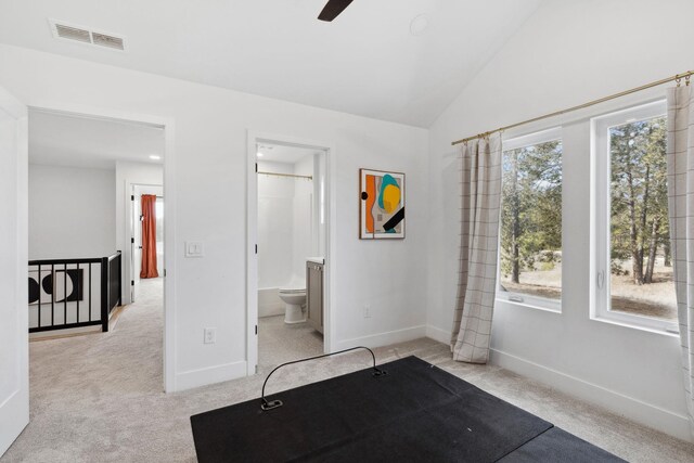 unfurnished bedroom with lofted ceiling, carpet flooring, baseboards, and visible vents