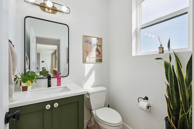 bathroom featuring toilet and vanity