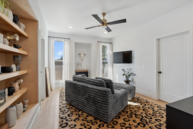 living area featuring recessed lighting, baseboards, light wood-style floors, and a ceiling fan