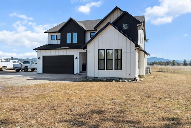 modern inspired farmhouse with an attached garage, cooling unit, board and batten siding, and crawl space