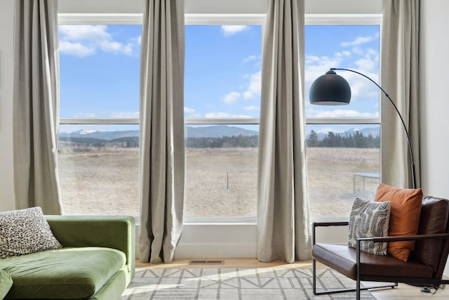 sitting room featuring visible vents and wood finished floors