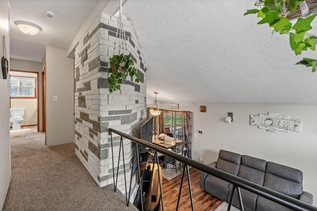 hall with a textured ceiling and carpet