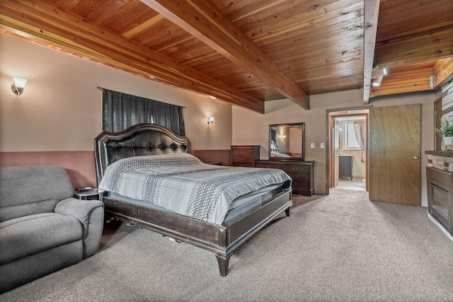 bedroom featuring beam ceiling, connected bathroom, wooden ceiling, and carpet floors