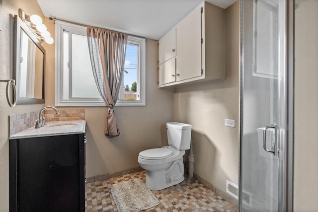 full bathroom featuring visible vents, a shower stall, baseboards, toilet, and vanity