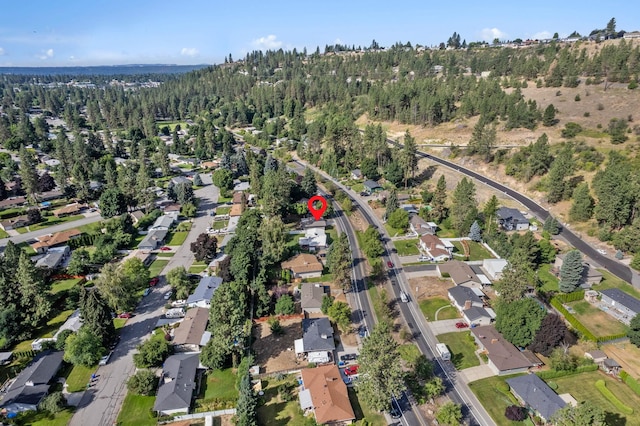 bird's eye view featuring a wooded view