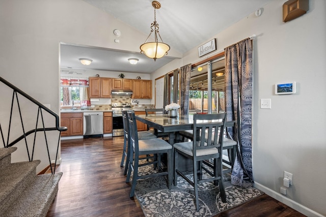 dining area featuring baseboards, lofted ceiling, dark wood-type flooring, and stairs