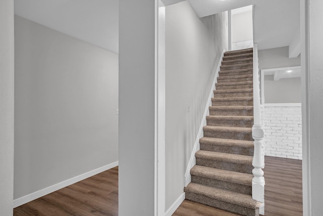 stairs with baseboards and wood finished floors