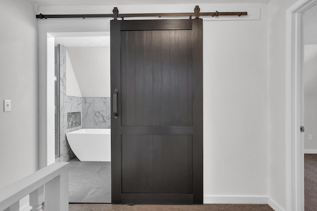 full bathroom with tile walls and a freestanding tub