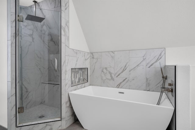 full bath featuring a marble finish shower, marble finish floor, a freestanding bath, and tile walls