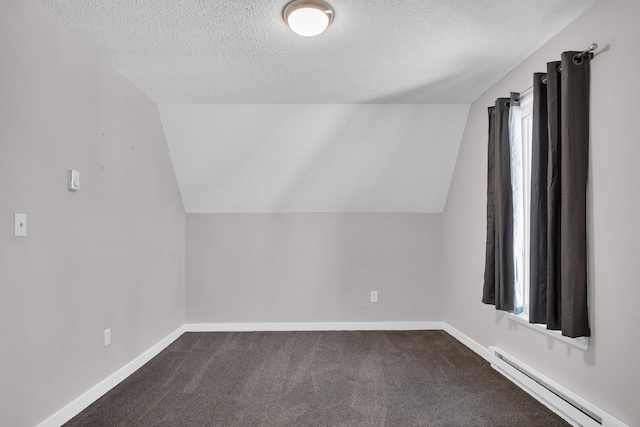 bonus room with baseboard heating, dark carpet, a textured ceiling, and lofted ceiling