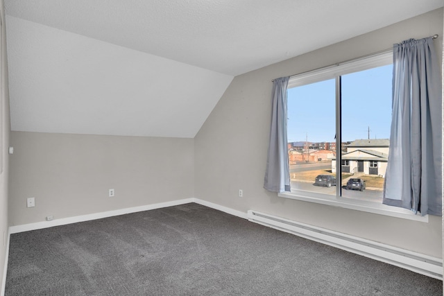 bonus room featuring a baseboard heating unit, lofted ceiling, baseboards, and carpet flooring