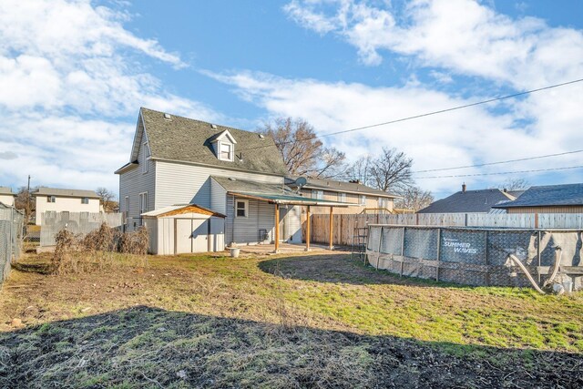 2523 N Nevada St, Spokane, WA 99207 - rear view of house featuring a fenced backyard, an outbuilding, and a shed
