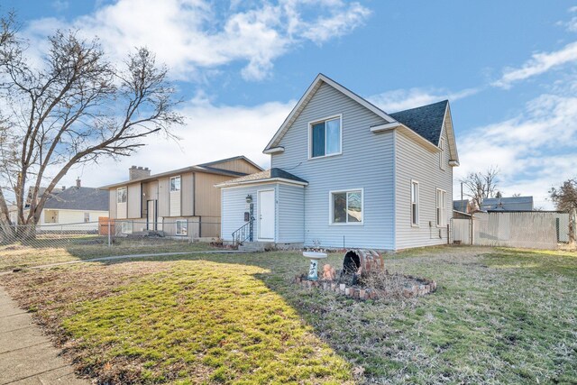 2523 N Nevada St, Spokane, WA 99207 - exterior space with a yard, entry steps, fence, and roof with shingles