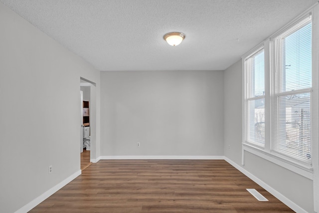 2523 N Nevada St, Spokane, WA 99207 - unfurnished room featuring baseboards, a textured ceiling, visible vents, and wood finished floors