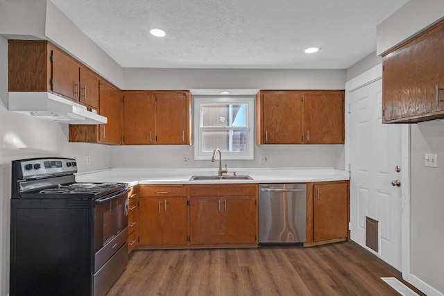 kitchen with range with electric cooktop, under cabinet range hood, dark wood-style flooring, stainless steel dishwasher, and a sink