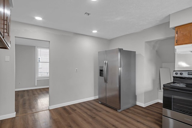 kitchen with under cabinet range hood, baseboards, dark wood-style flooring, and appliances with stainless steel finishes