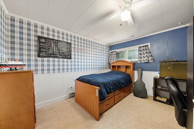 bedroom featuring visible vents, a wainscoted wall, wallpapered walls, ceiling fan, and carpet flooring