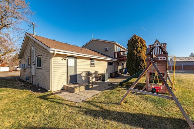 back of property featuring a playground, central air condition unit, cooling unit, a yard, and a patio