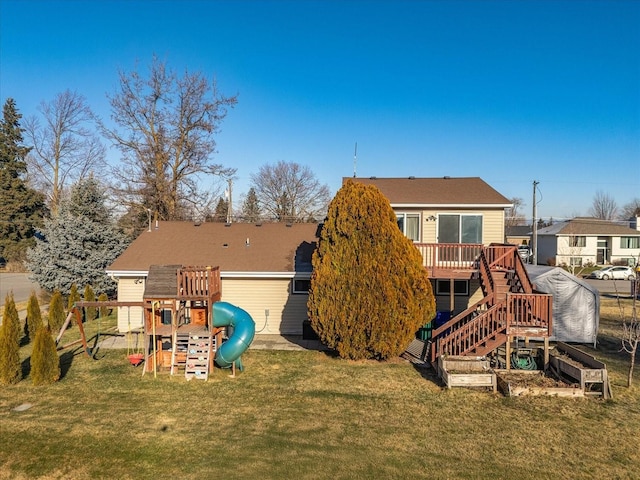 view of jungle gym with stairs, a deck, and a yard