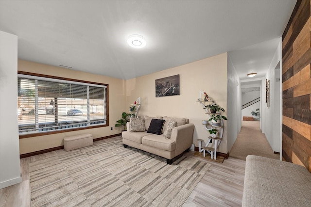 living area with baseboards and wood finished floors