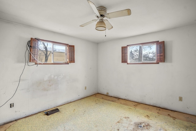 empty room with a healthy amount of sunlight and ceiling fan