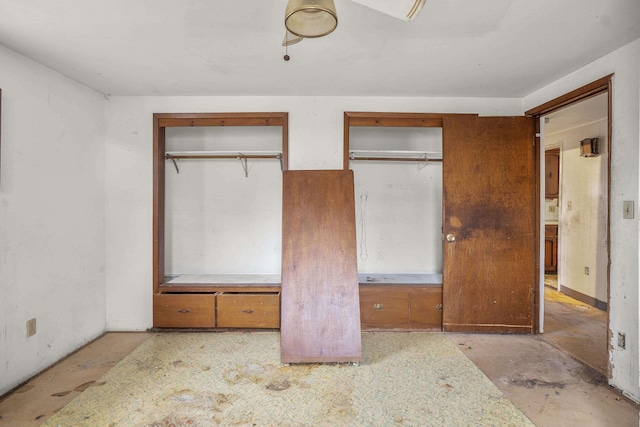 unfurnished bedroom with two closets