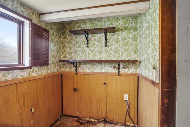 interior details featuring wainscoting and wallpapered walls