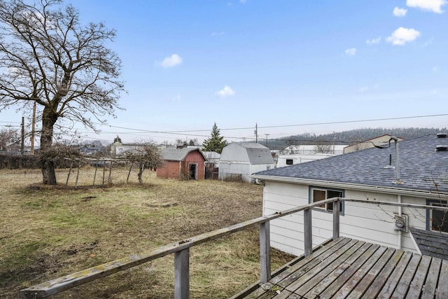 wooden deck with an outbuilding