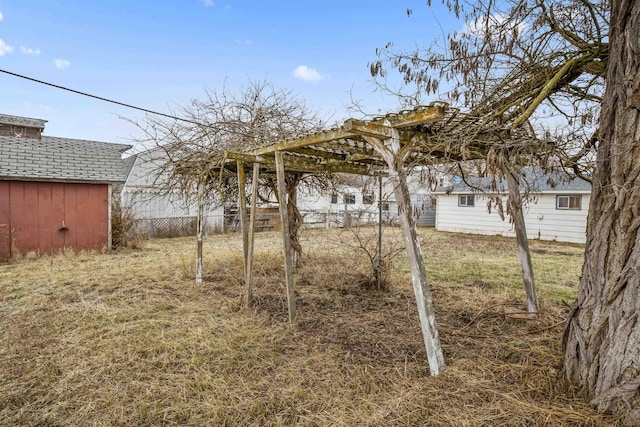 view of yard with an outbuilding and fence