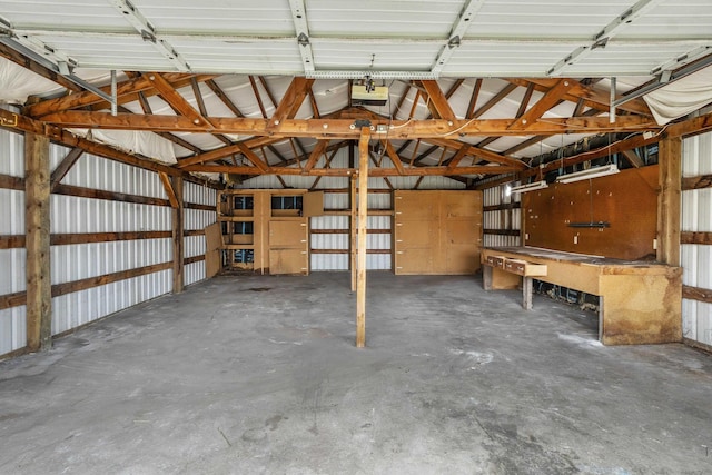 garage featuring a garage door opener and metal wall