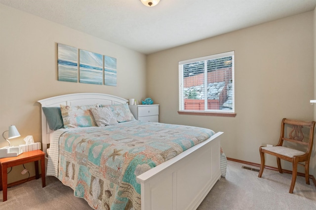 bedroom with light carpet, visible vents, and baseboards