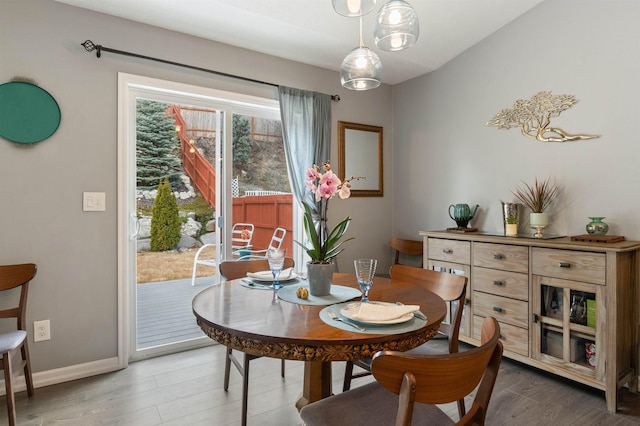 dining room with baseboards and wood finished floors