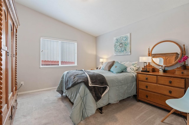 bedroom featuring light colored carpet, baseboards, and lofted ceiling