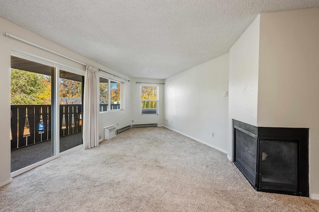 unfurnished living room featuring a multi sided fireplace, carpet flooring, a textured ceiling, and baseboards