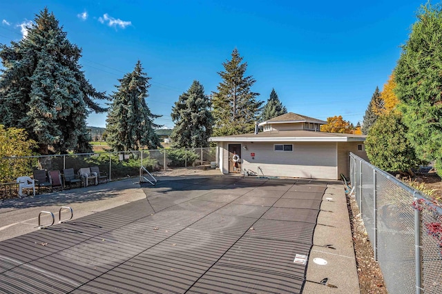 view of front of home with a patio area and fence