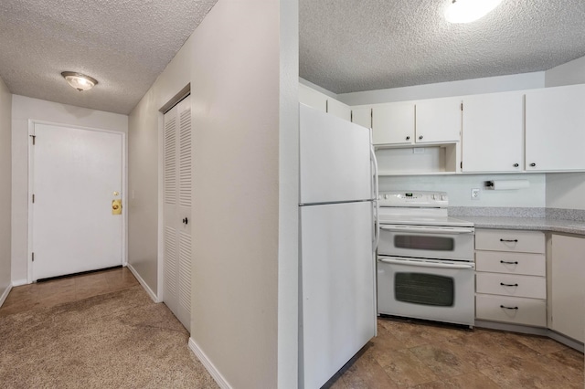 kitchen with baseboards, light countertops, white cabinets, white appliances, and a textured ceiling