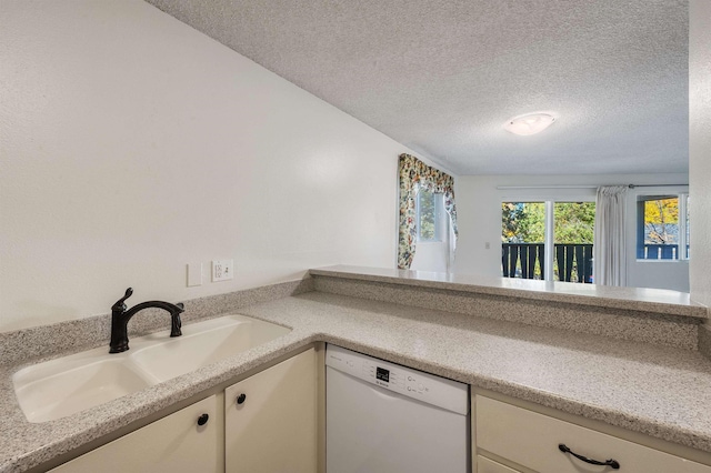 kitchen featuring white dishwasher, a sink, light countertops, a textured ceiling, and white cabinetry