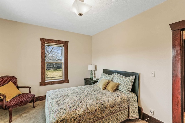 carpeted bedroom with a textured ceiling