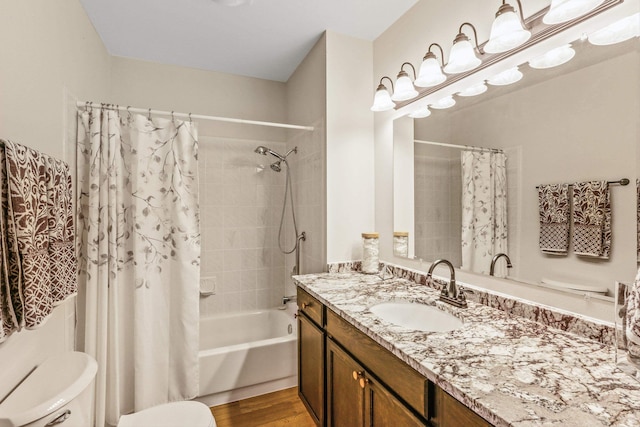 full bath with vanity, shower / tub combo, toilet, and wood finished floors