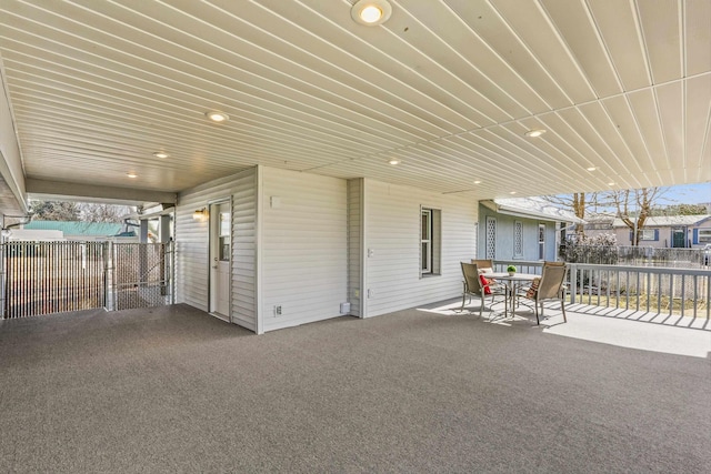 view of patio featuring outdoor dining space and fence