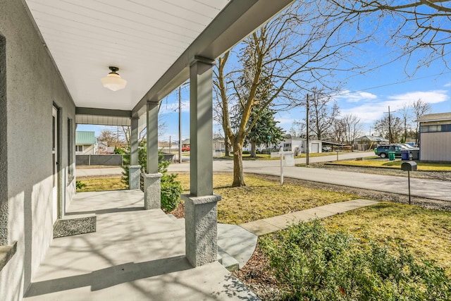 view of yard featuring a residential view and a porch