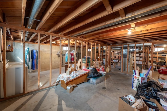 unfinished basement featuring washing machine and dryer