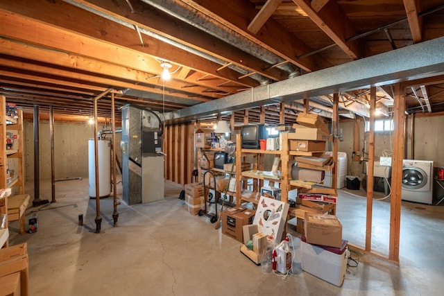 basement with water heater and washer / clothes dryer