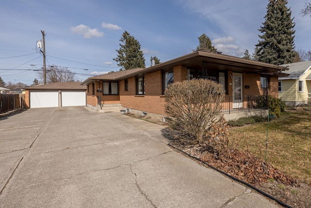 ranch-style home featuring a detached garage, brick siding, an outdoor structure, and fence