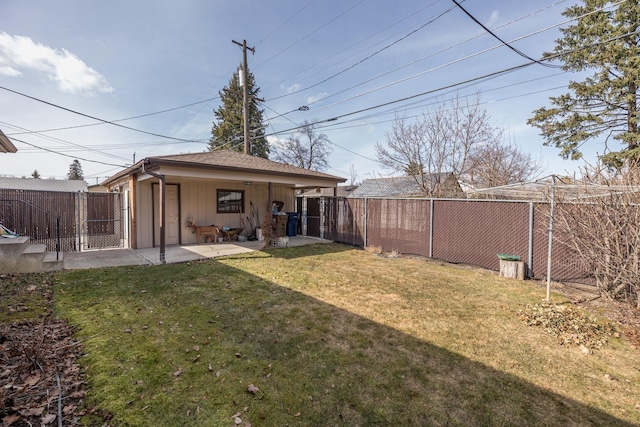 view of yard with a gate, a fenced backyard, and a patio area