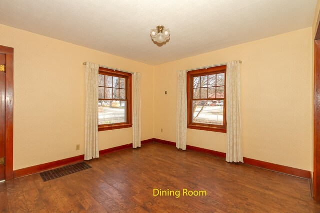 460 E Columbia Ave, Colville, WA 99114 - spare room featuring dark wood-style floors, healthy amount of natural light, and baseboards