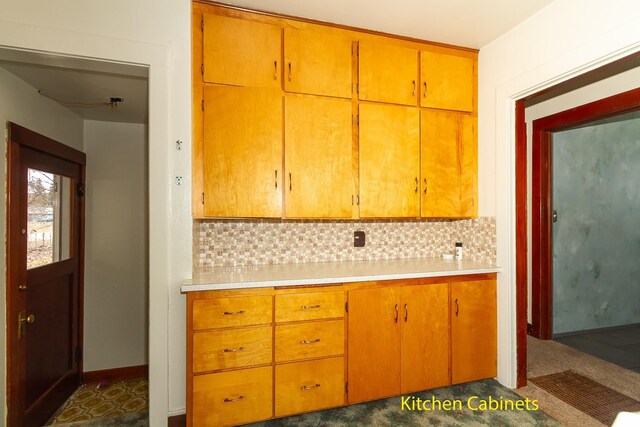 460 E Columbia Ave, Colville, WA 99114 - kitchen featuring decorative backsplash, light countertops, baseboards, and brown cabinetry